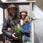 Next 7 Organic Farm focuses on sustainability for future generations A man and a woman stand in front of a greenhouse with a hemp plant.