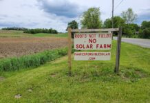 Solar debate hits western Pennsylvania farming communities a sign reading roofs not fields no solar farm sits along a road with farm fields in the background