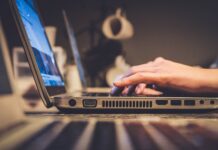 Ohio communities explore broadband plans through program person using silver laptop computer on desk