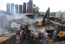 Is your dairy prepared for a disaster? men watch an excavator dig in remains of a barn fire