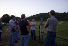 Grace Meadows Farm uses pasture management to grow contract grazing, beef cattle operations A group of farmers stand near a fence at a beef cattle farm.