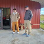 Veteran uses Pennsylvania farm to recover from impacts of war two men standing together in front of a farm store
