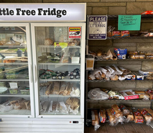 Rescuing food for Aliquippa open "little free fridge" with food sits beside an open shelf of food
