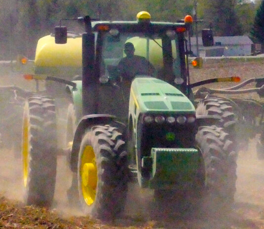 Stark Co. farmer Ben Klick embraces technology, new challenges tractor plowing field kicking up dust