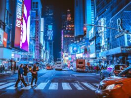 people walking on pedestrian lane during night time