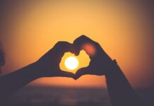 The key to a happy marriage silhouette of person's hands forming heart