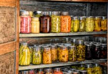 Doing the harvest time hustle a wooden shelf filled with lots of jars of food