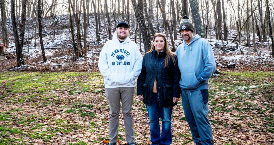 green-county-feature Tannar, Kimberly and Tom Barton stand in their backyard in Alicia, Pennsylvania on Dec. 7, 2025. The former Robena Coal Mine site is further up the hill.