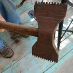 Can you identify this double-sided serrated axe?