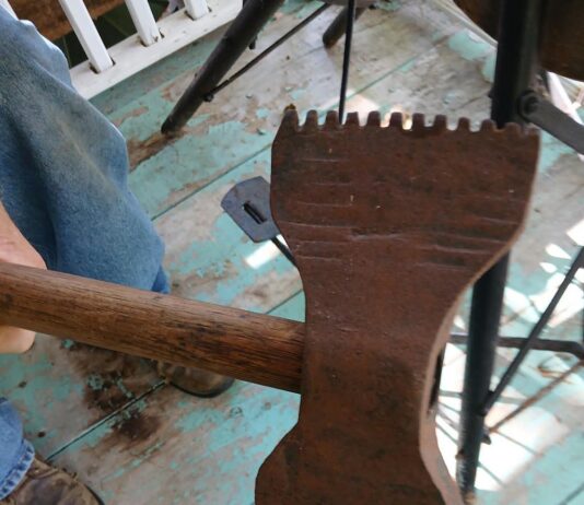 Can you identify this double-sided serrated axe?