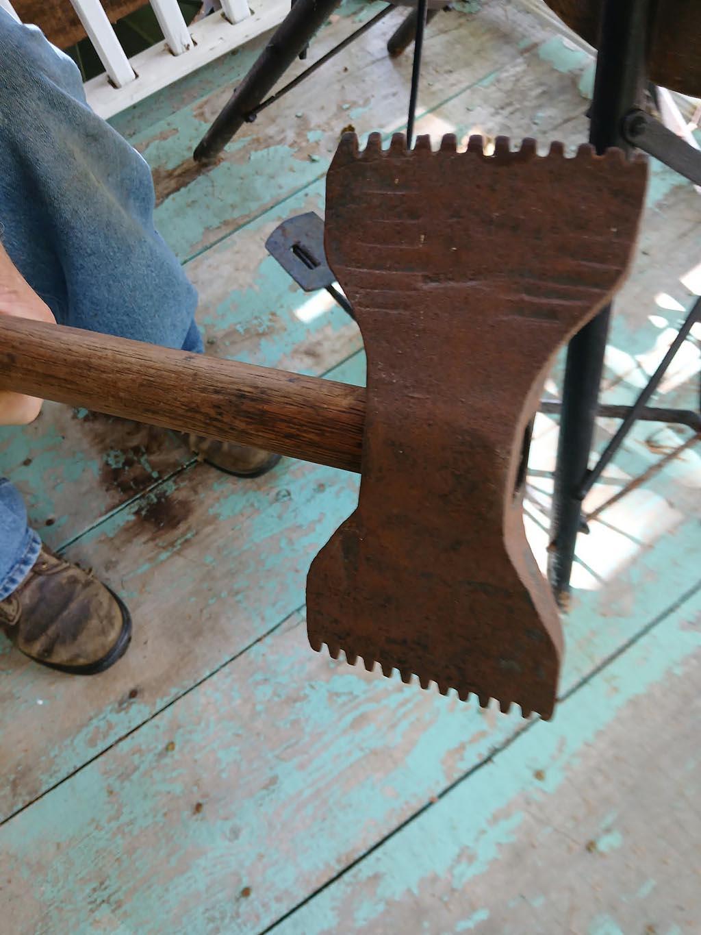 Can you identify this double-sided serrated axe?