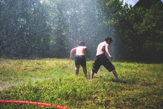 hose kids playing sprinkler