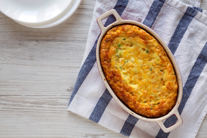 Homemade Cheddar Corn Pudding Casserole, overhead view. Flat lay