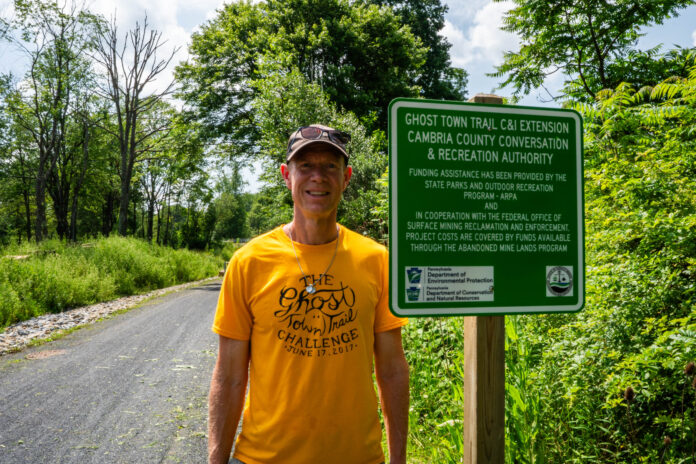 cliff next to ghost town sign Cliff Kitner