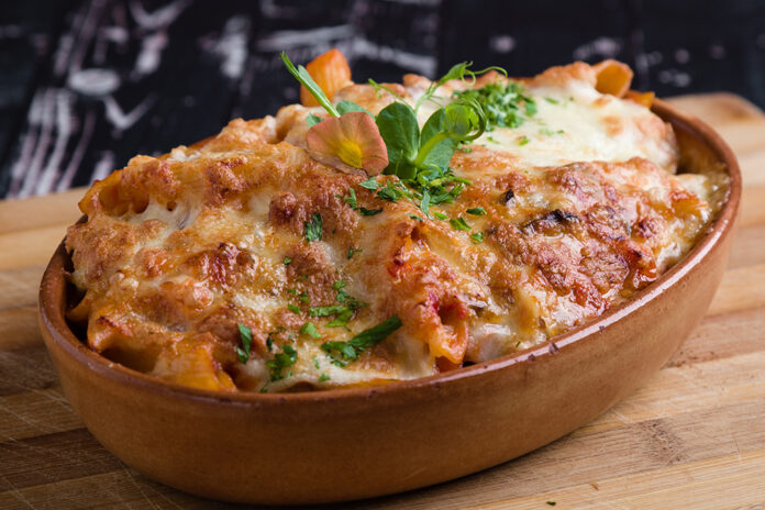 tasty delicious penne rigate pasta in rustic bowl